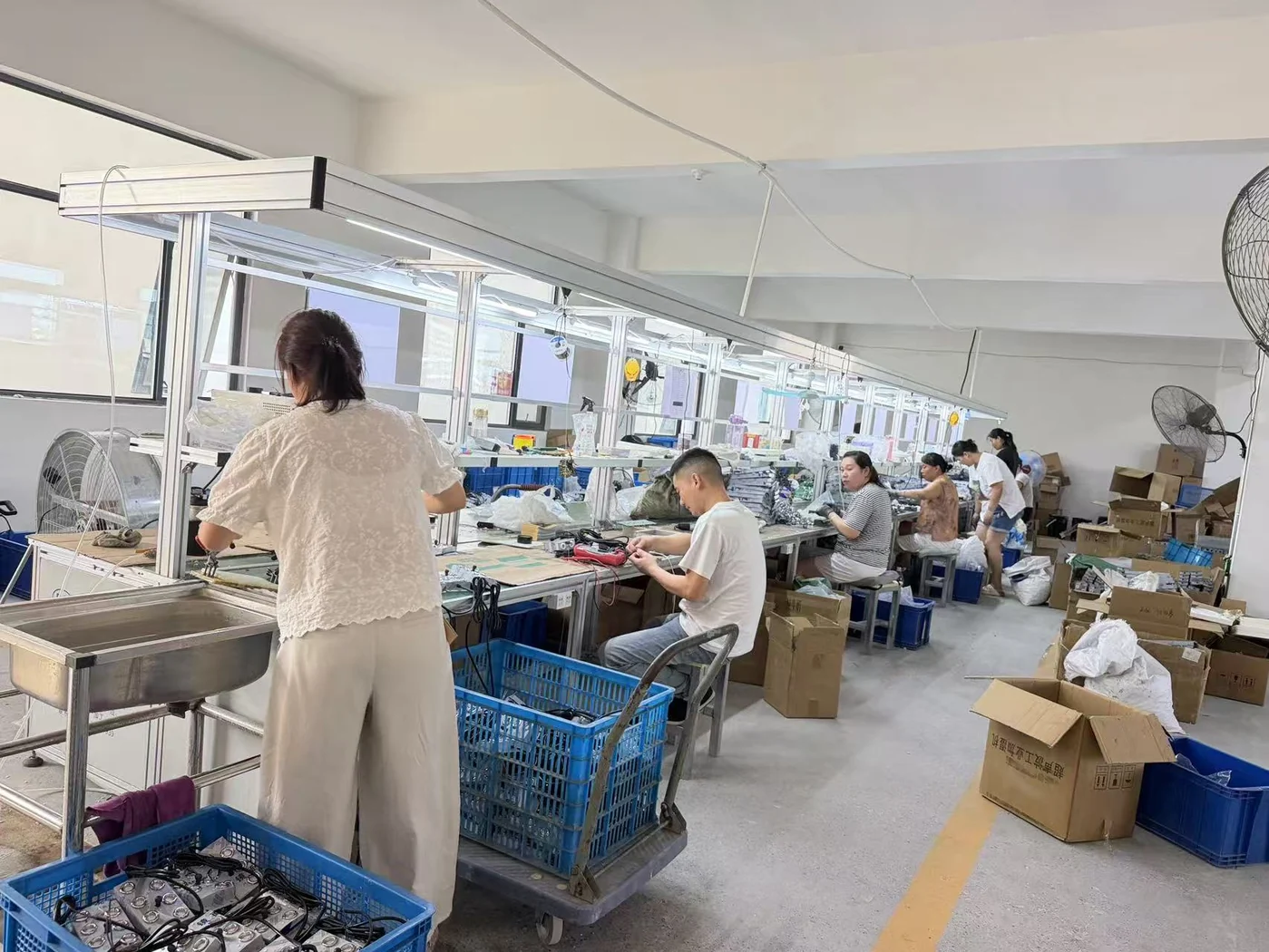 Workers assembling ultrasonic atomizer modules at the PHIMAXX manufacturing facility
